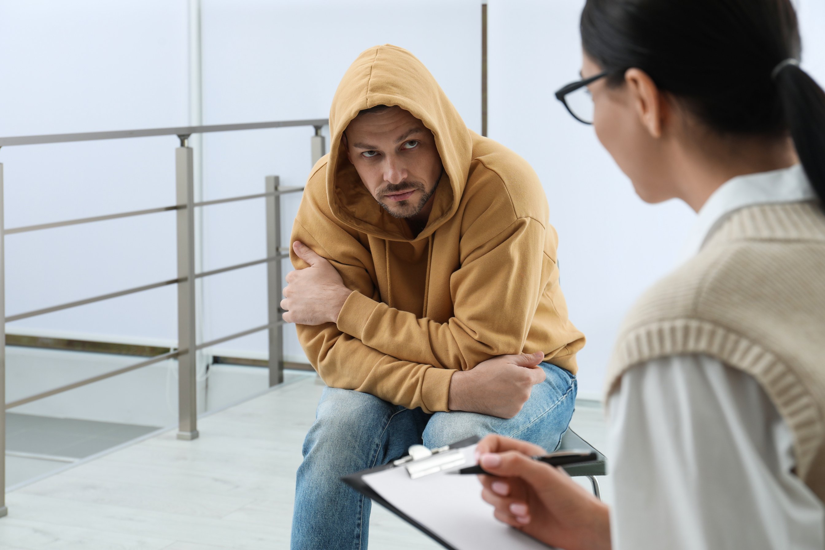 Psychotherapist Working with Drug Addicted Man Indoors